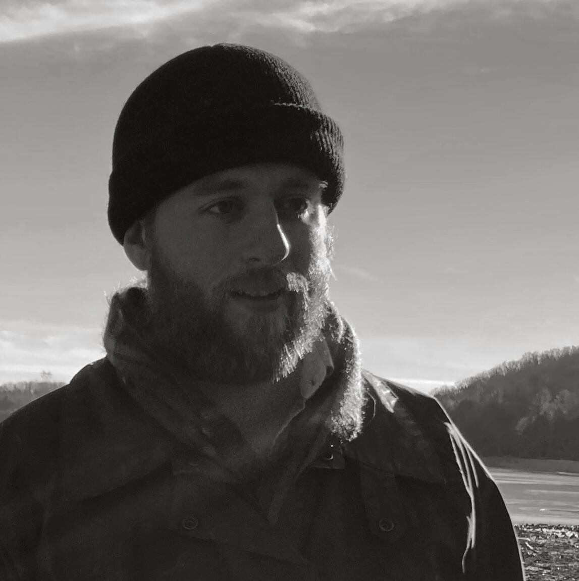 Patrick Kniesler A man with a trustworthy beard, wrapped up against the cold in an outdoor setting.